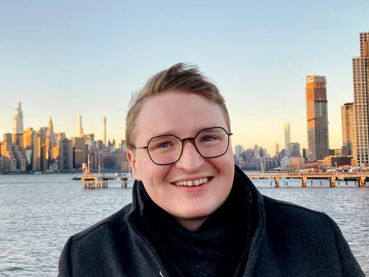 Ian J. McKnight smiles in front of a river. And, if you're wondering, he looks really great.